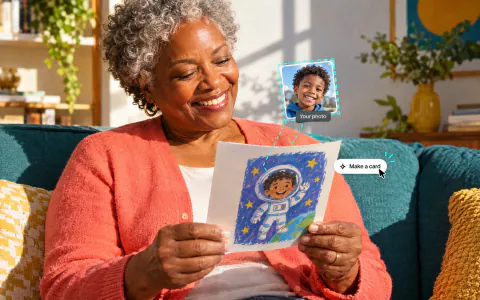 A grandmother on a teal sofa smiling at a birthday card with her grandson drawn as a cartoon astronaut, made from his photo