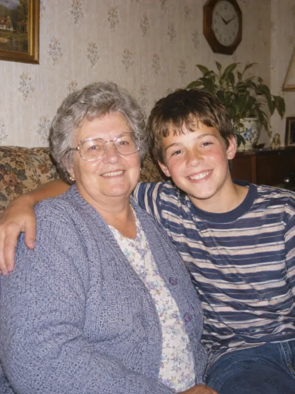 Grandmother and her grandson on a sofa in a 1990s film photo, coming to life in a short video
