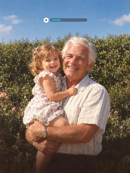 Old film photo of a grandfather holding his granddaughter with a play button and a video timeline