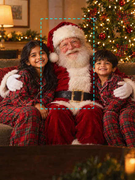 Two kids in pajamas on a sofa with Santa sitting between them, a dashed selection around Santa